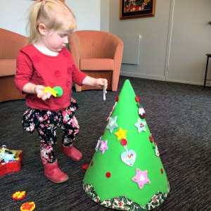 Cassie decorating her felt Christmas tree